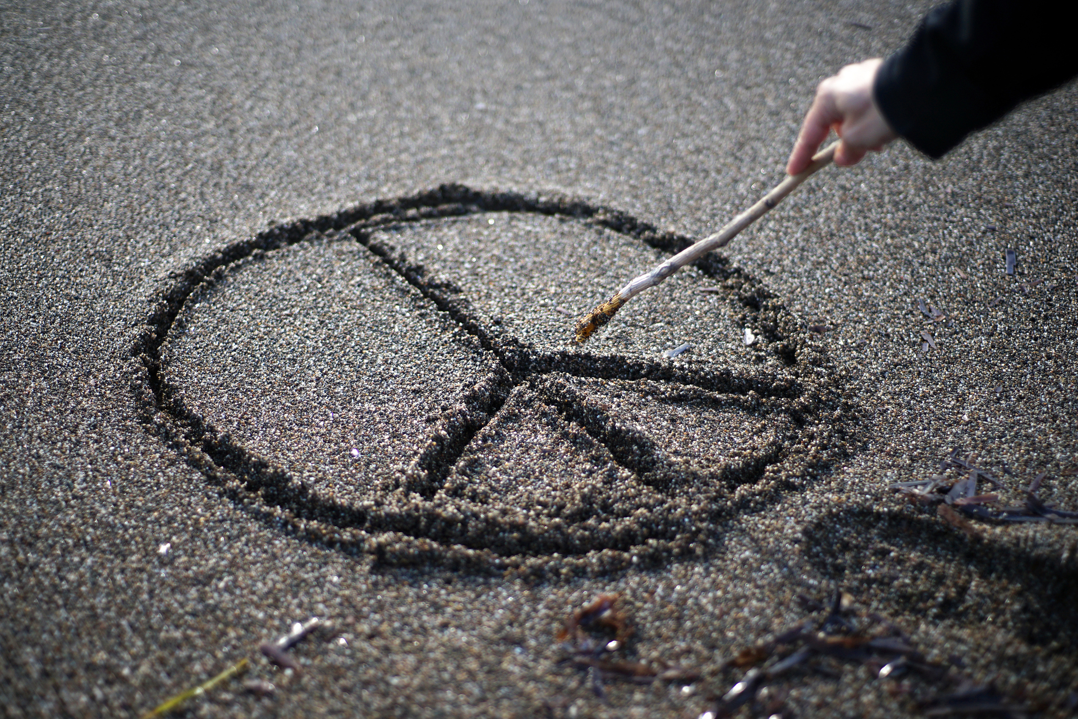 Peace symbol in sand
