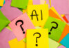 Are we asking the wrong questions about using AI? A collection of colourful sticky notes with question marks and "AI" written on them.