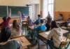 Is it time for a ‘coacher’ yet? students with hands up in classroom