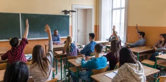Is it time for a ‘coacher’ yet? students with hands up in classroom