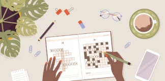 Teaching vocabulary illustration of hand completing crossword