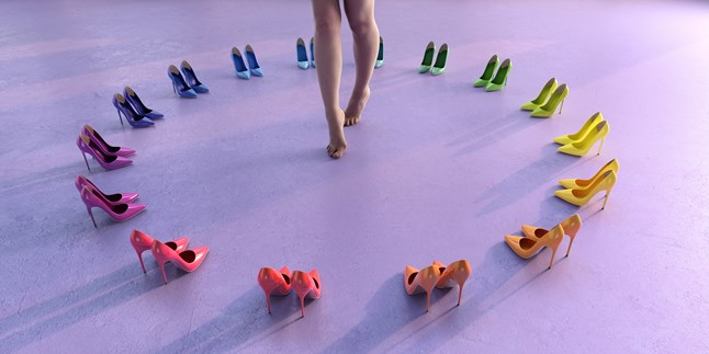 A person walking barefoot in the center of a circle formed by pairs of high-heeled shoes in various colors, arranged on a purple surface.