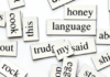 Blending meanings Magnetic poetry tiles with various words such as 'honey,' 'language,' 'ship,' and 'blow' scattered across a white surface.