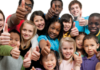 In need of rebranding A diverse group of children and teenagers giving thumbs up against a white background.