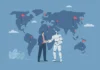 Working in international teams: how AI can (and cannot) help Illustration of a human and a robot shaking hands in front of a world map with red flags and connecting lines, symbolizing global collaboration in technology or artificial intelligence.