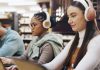 From struggle to success Three students working on laptops with headphones on