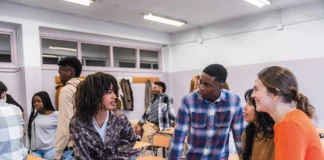 Can you give me a hand? students discussing in classroom
