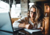 I want to write, but how? Woman writing with pen and paper while at laptop